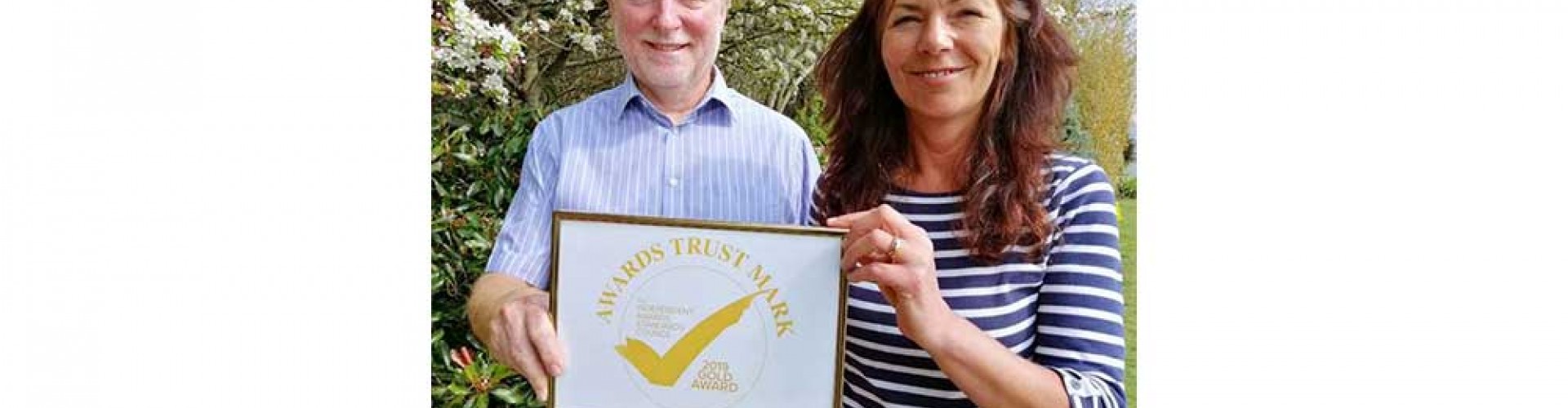 two people with awards trust mark