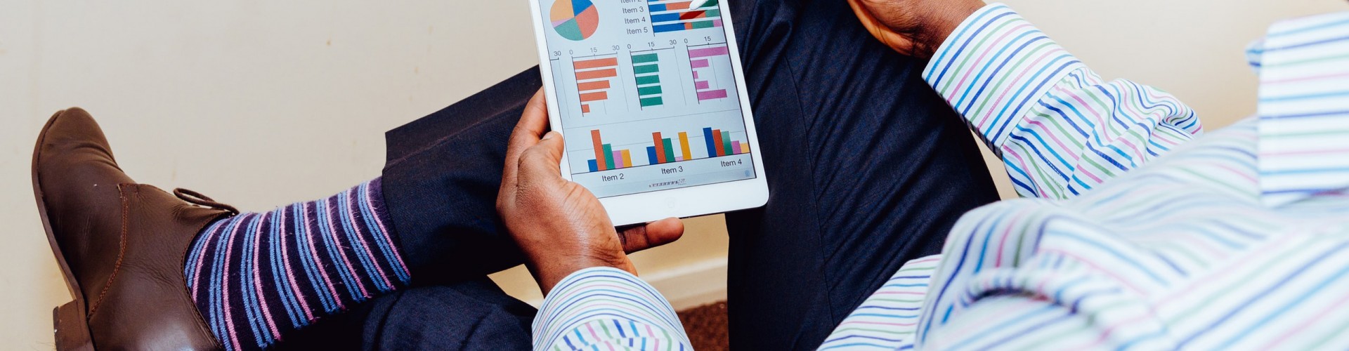 person looking at graphs on a tablet
