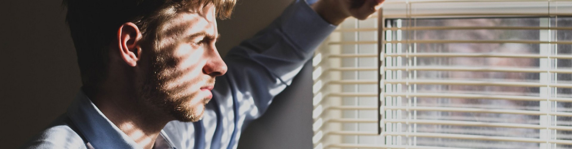 sad man looking out of window
