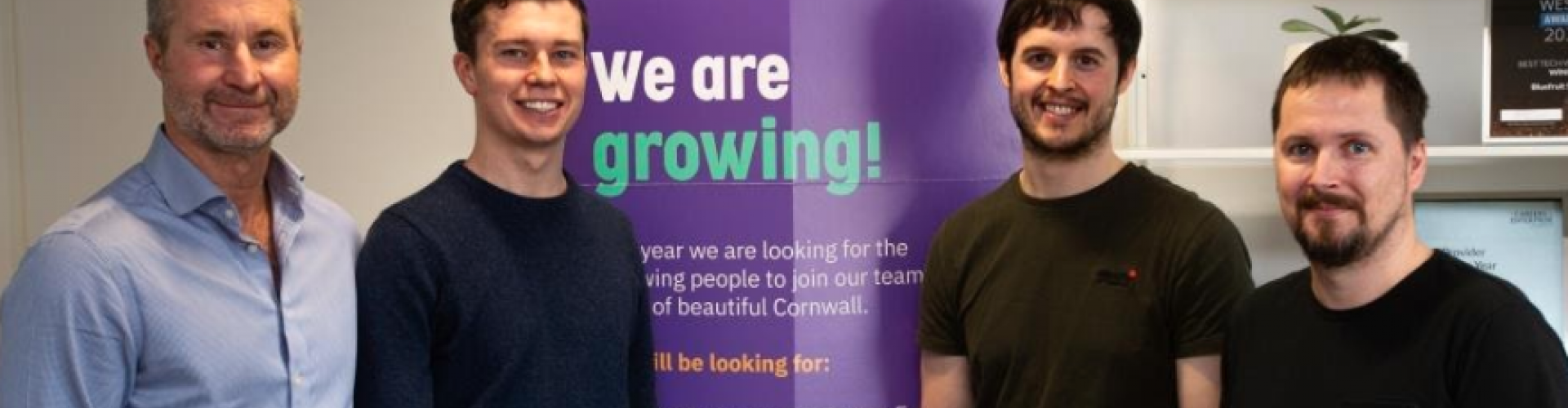 Software Cornwall four men posing in front of rollerbanner