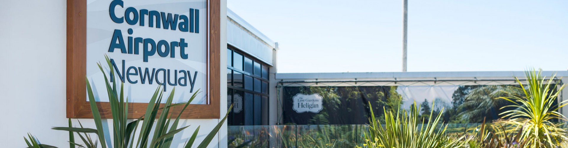 Cornwall Airport Newquay sign and exterior with plants