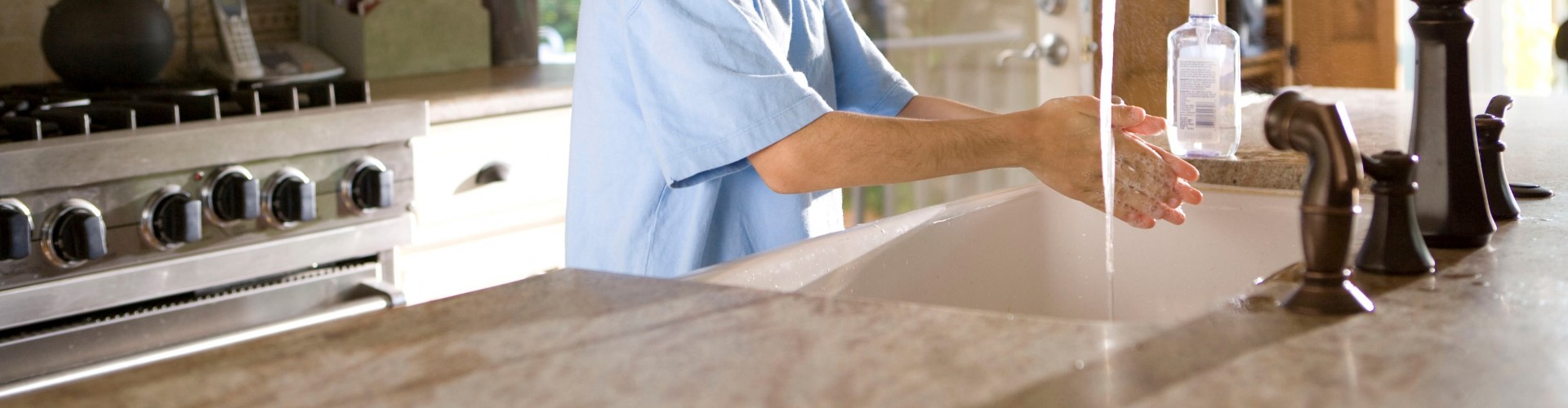 image of boy washing his hands at a sink