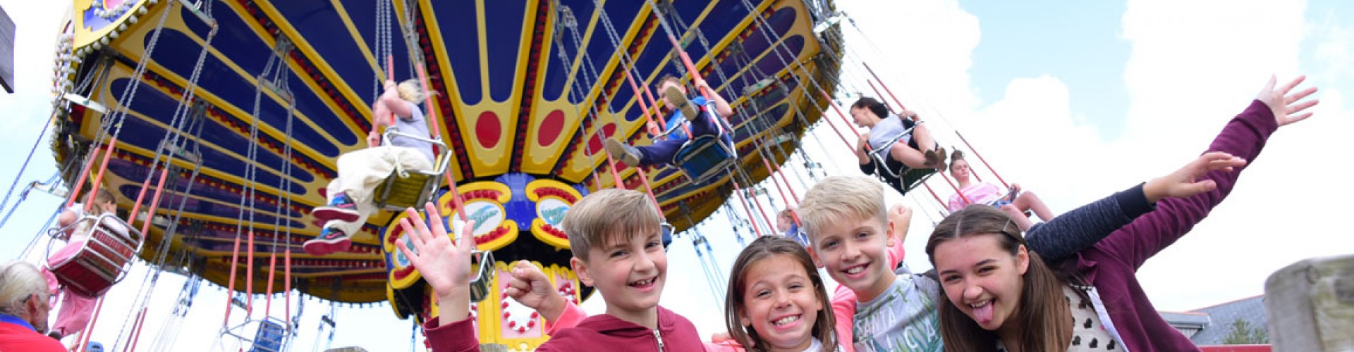 children in front of Camel Creek fairground ride