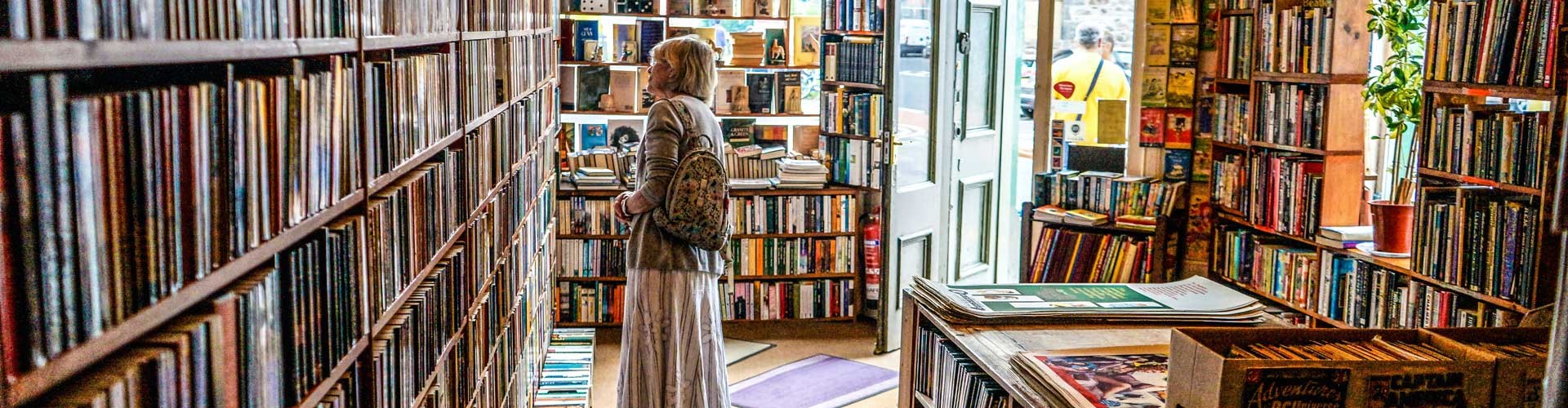 woman browsing shelves in book shop