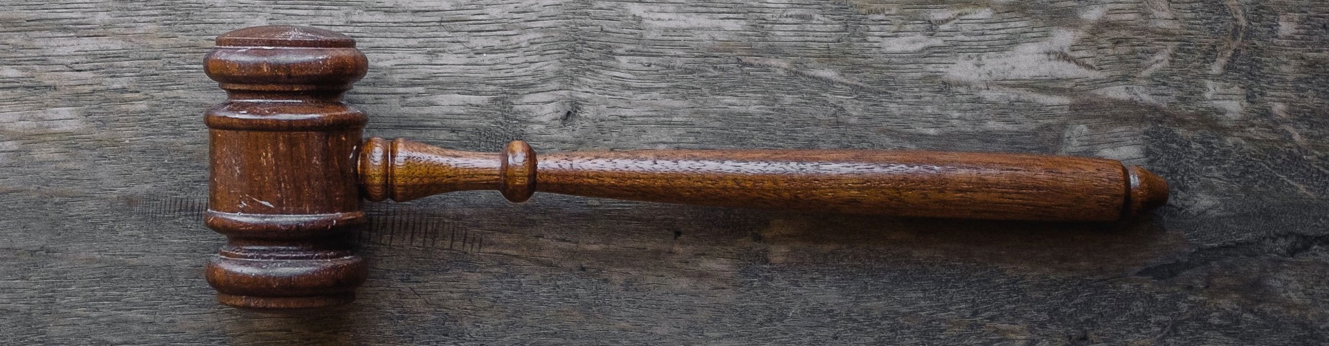 judge's gavel on grey wooden background