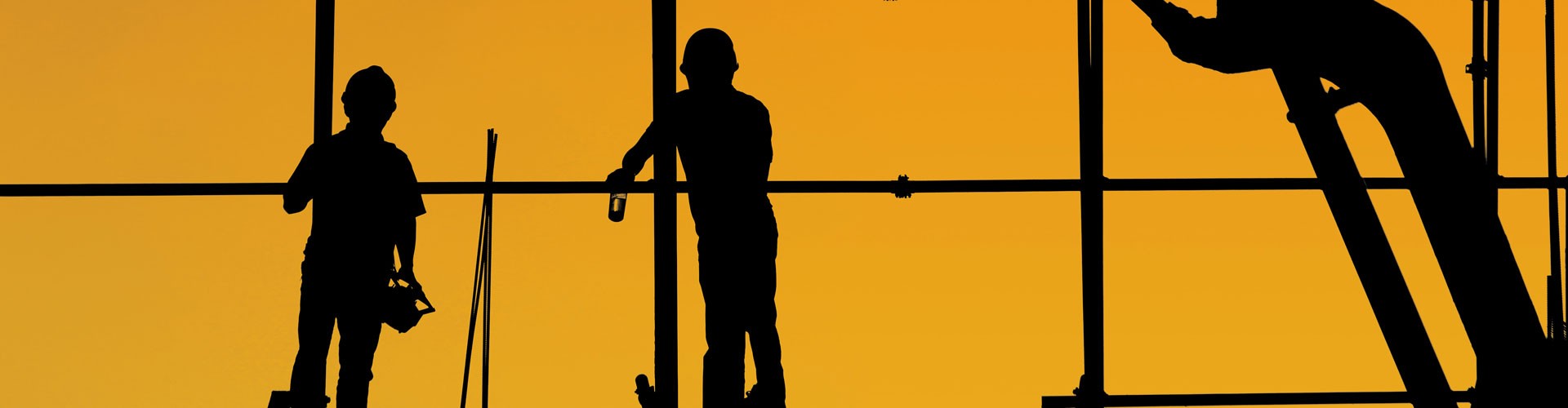 silhouetted builders against orange background