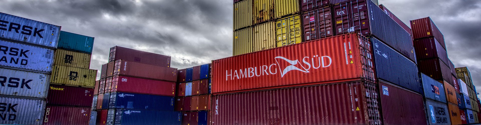 shipping containers against dramatic sky