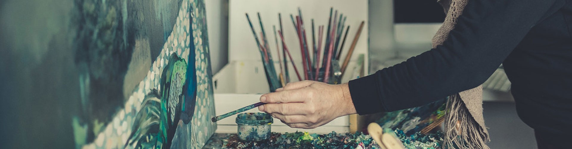 artist painting in her studio
