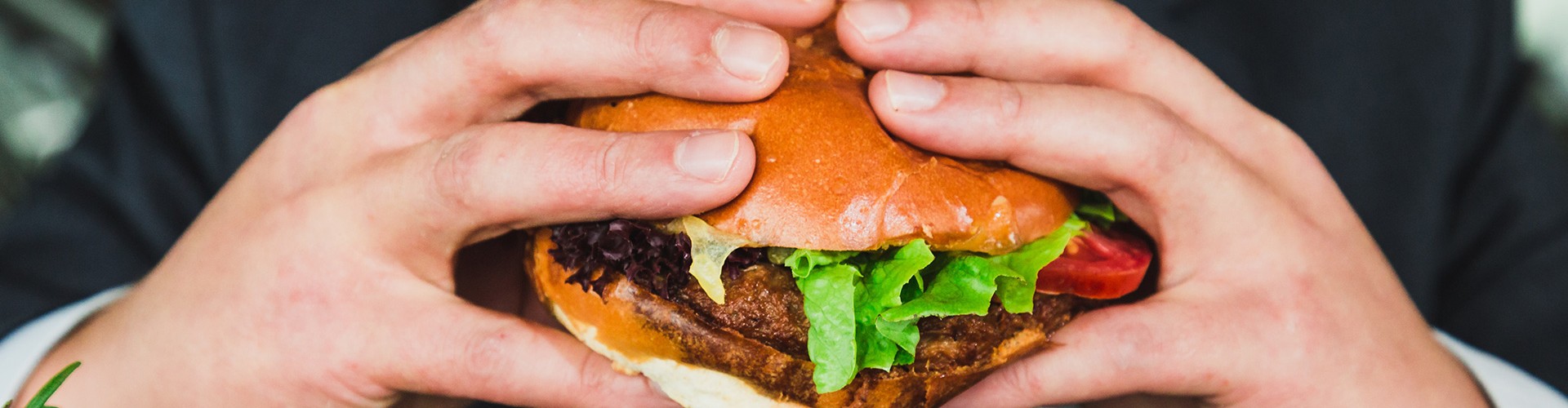 holding burger to eat 