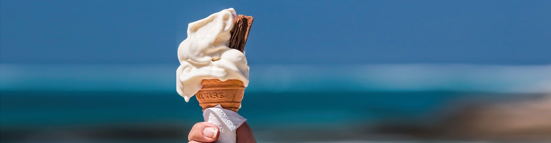 ice cream cone against blurred seascape background