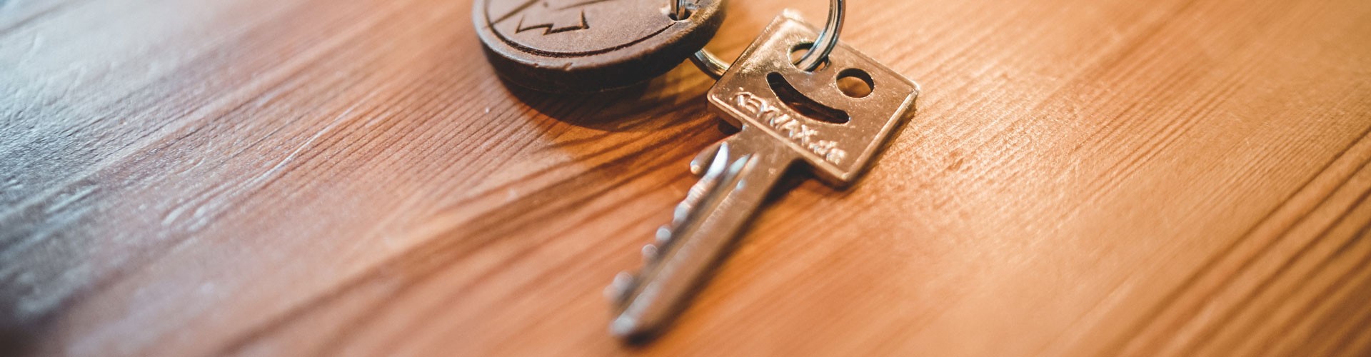 key with smiley face on wooden table