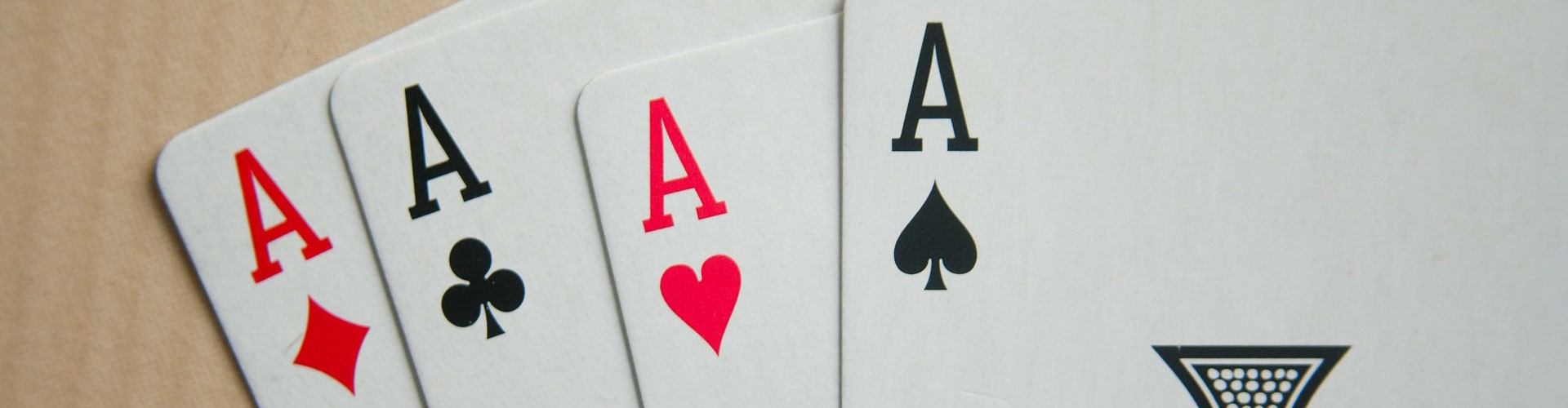a hand of playing cards showing all four aces