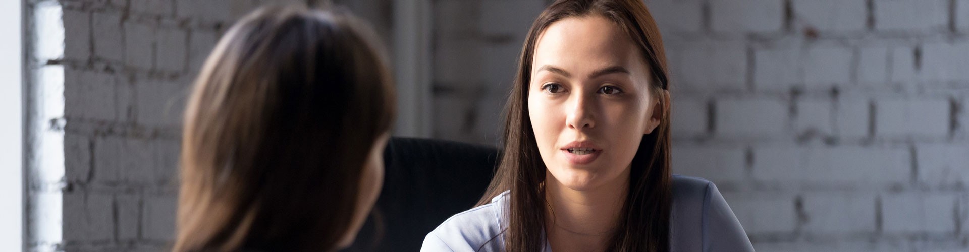 two women having a conversation in a business setting