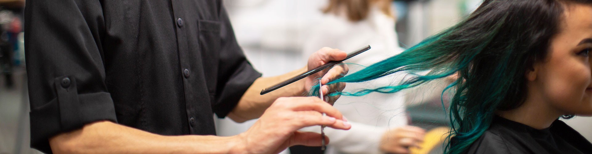 lady with blue hair having a trim