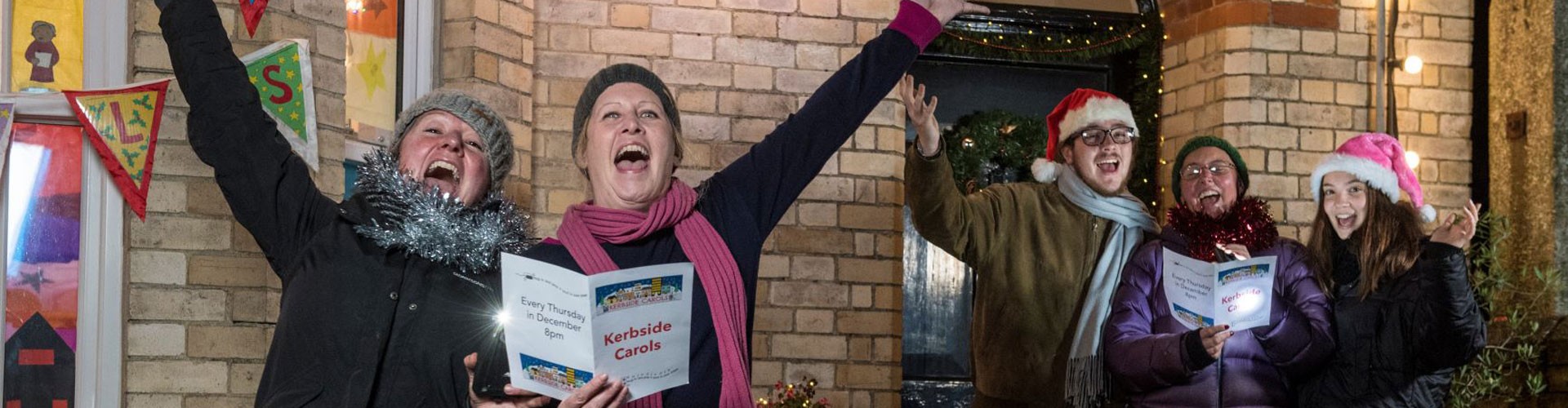 carol singers outside a house