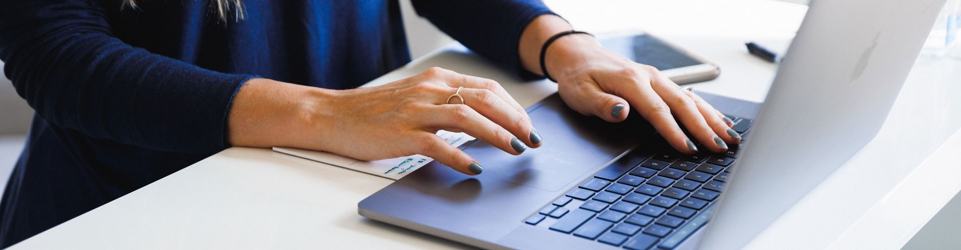 woman typing at laptop