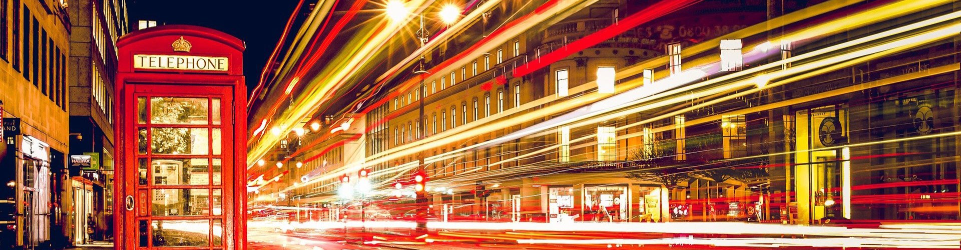 red telephone box and busy street at night time lapse