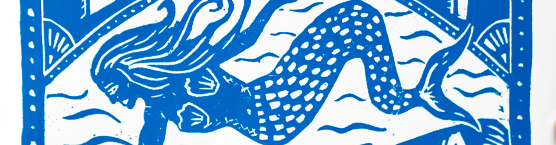 blue and white lino print of a mermaid from newquay