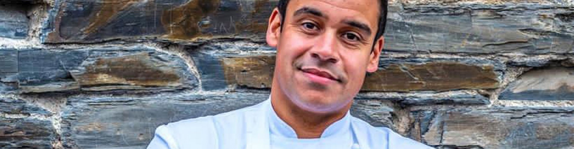 portrait of chef Paul Ainsworth against stone wall background