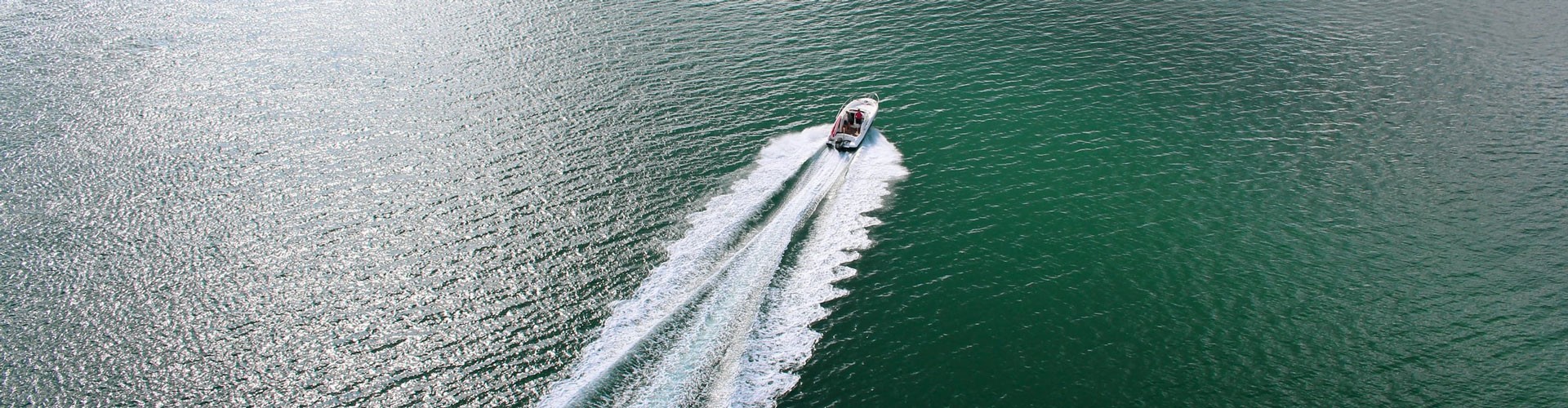 speedboat photographed from above on a calm green sea