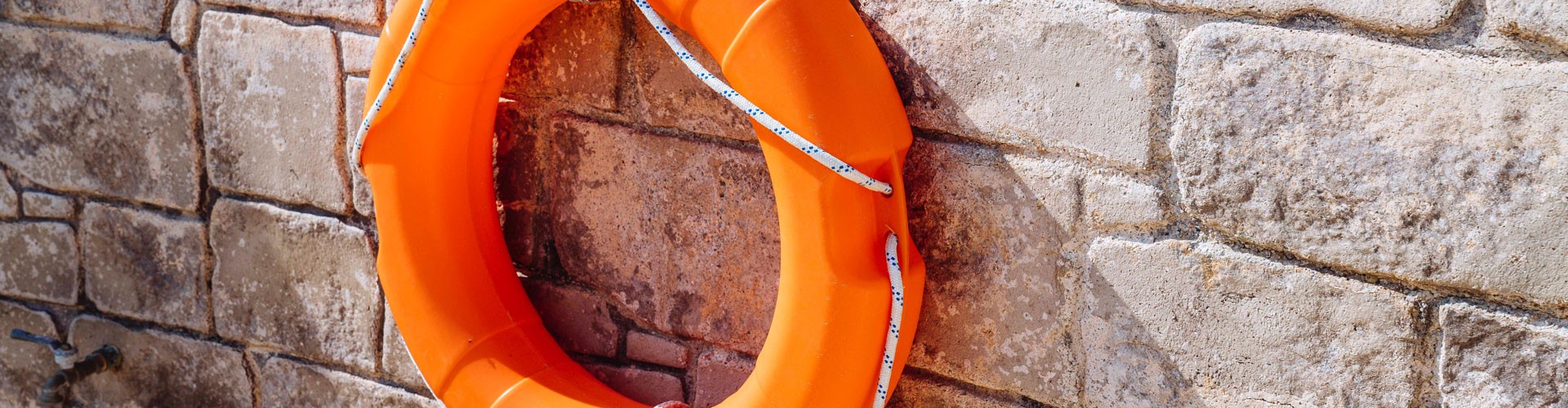 orange life bouy hanging on a wall