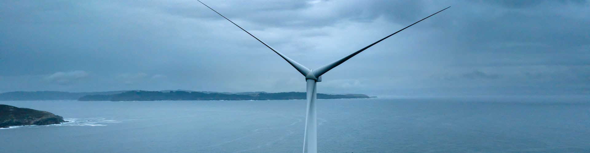 floating offshore wind turbine being towed out to sea