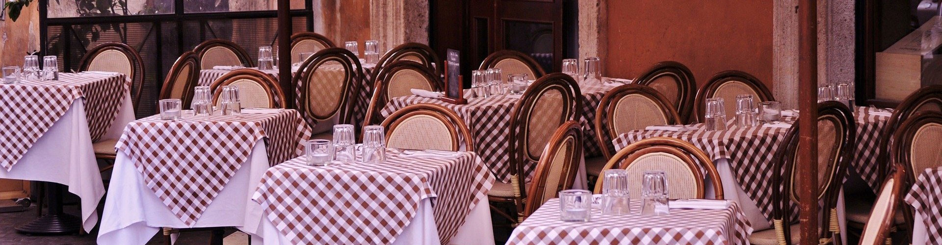 tables laid on pavement for bistro al fresco
