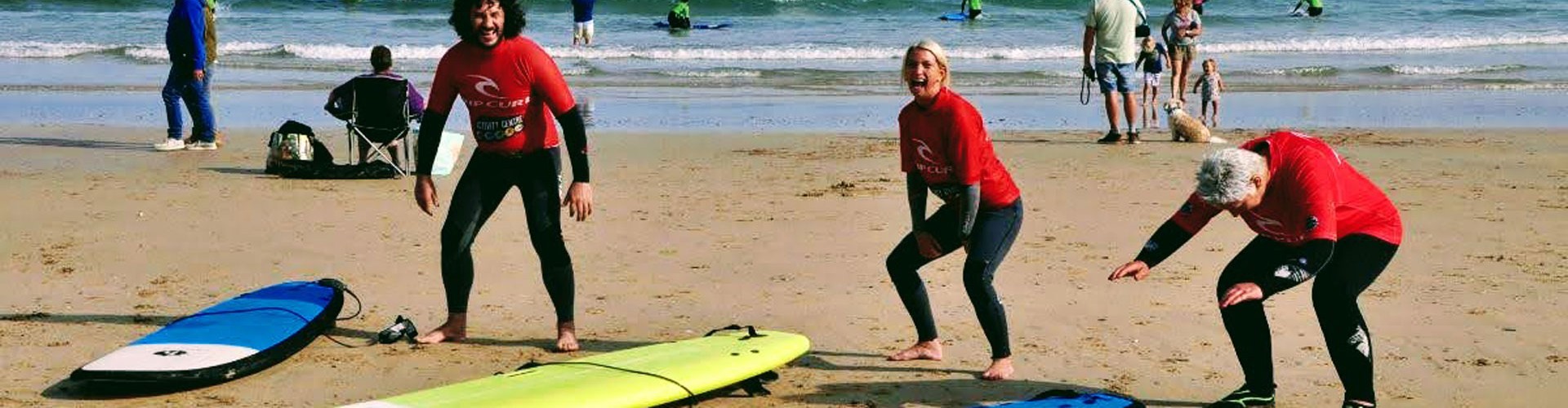 SeaChange clients on the beach with surfboards