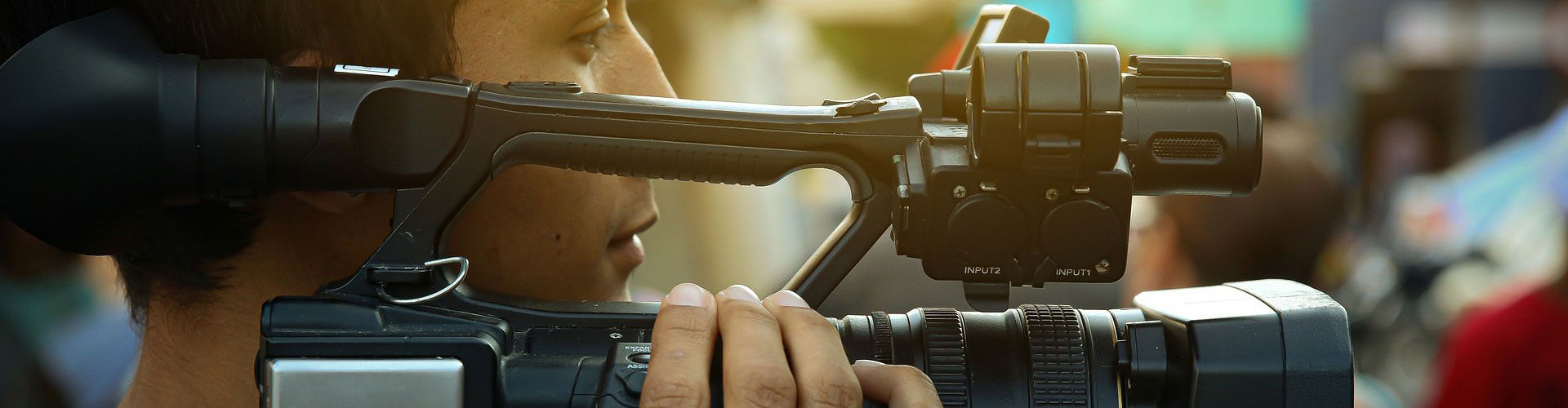 young man holding video camera