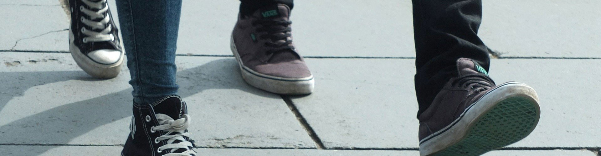 feet walking down pavement