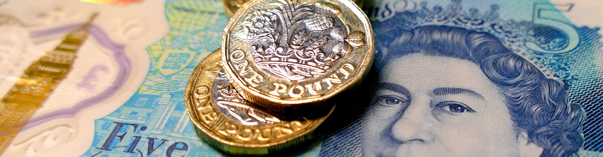 uk cash - five pound note and pound coins
