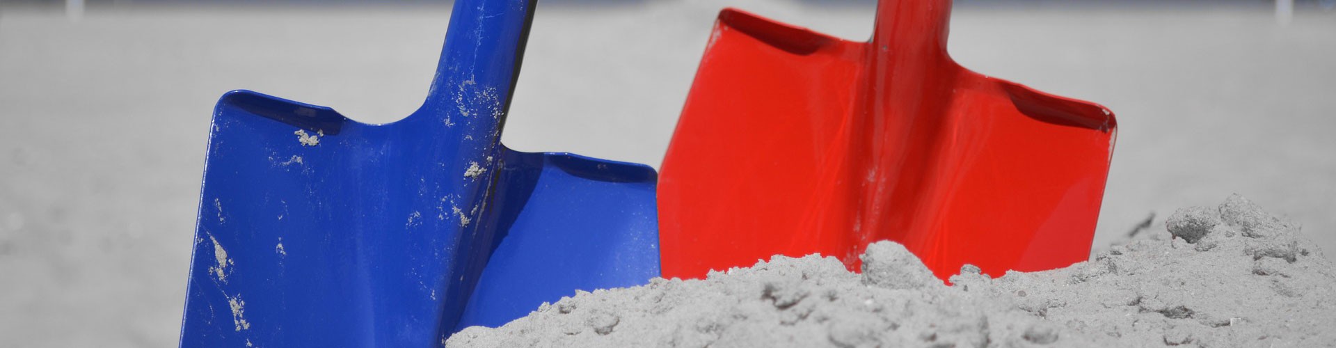 coloured spades in sand