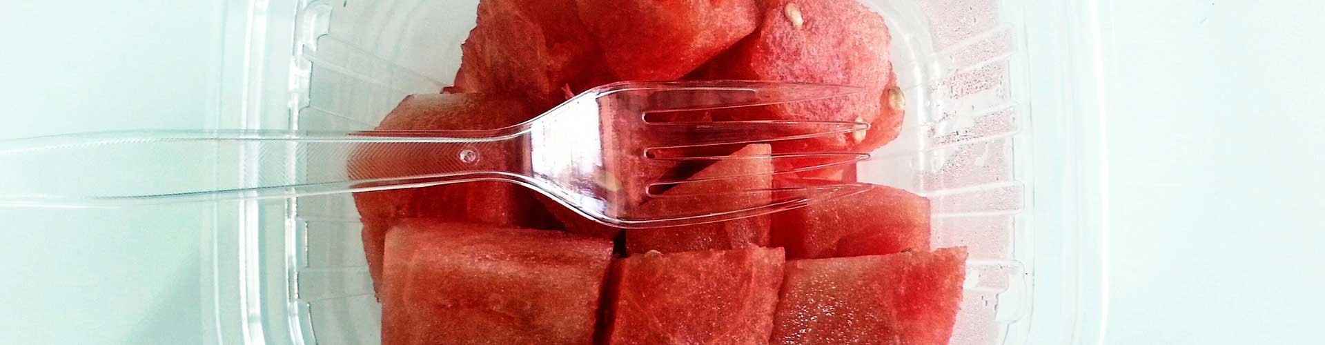 watermelon in plastic tub with plastic fork