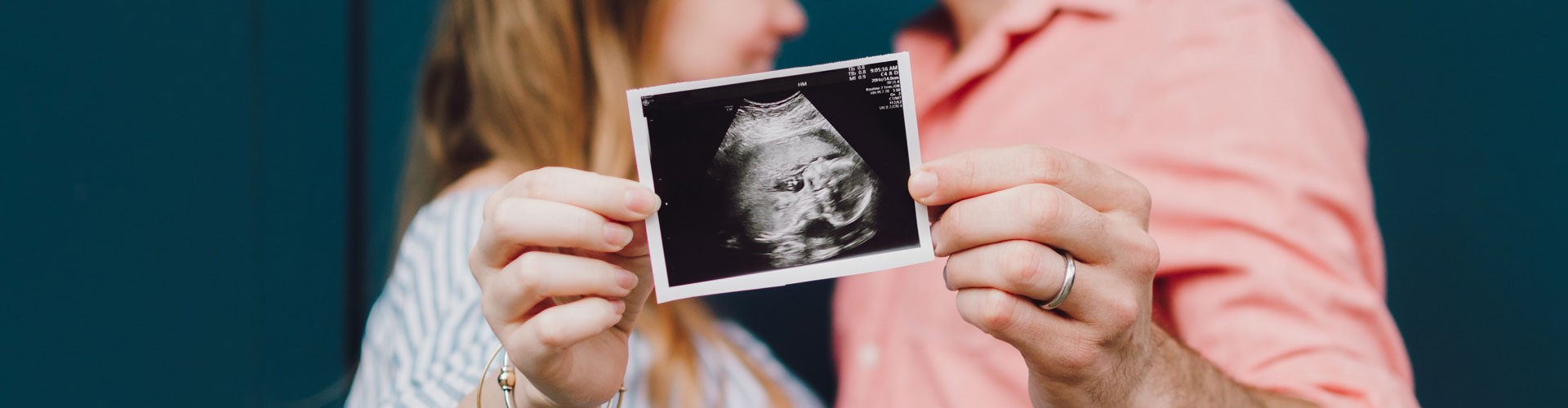 couple holding ultrasound image