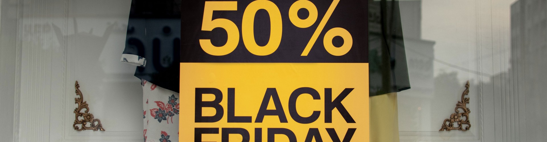 Black and yellow poster in a shop window advertising Black Friday