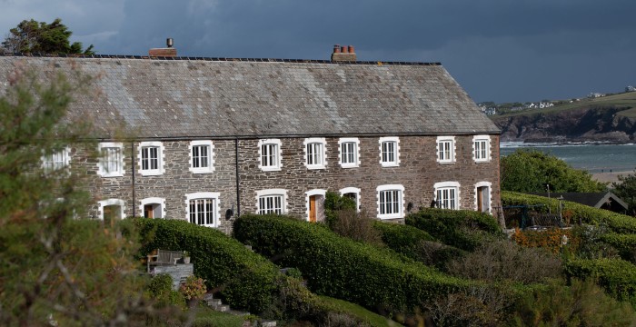 Old cottages looking out to sea in Cornwall, England.