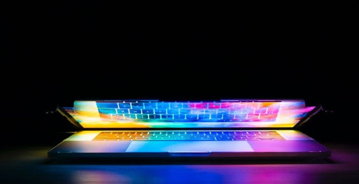 An opening laptop with rainbow colours