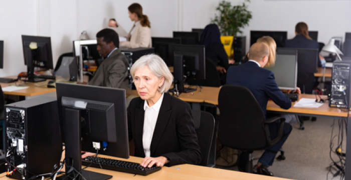 older lady in office looking unhappy