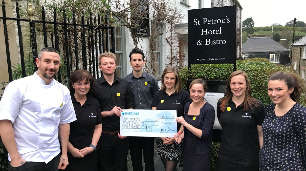 7 st petroc's bistro staff posing with a large cheque
