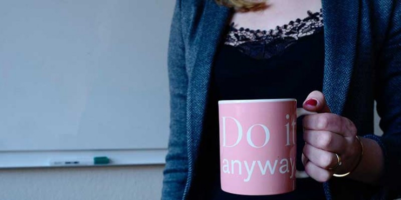 Person holding Do it anyway mug