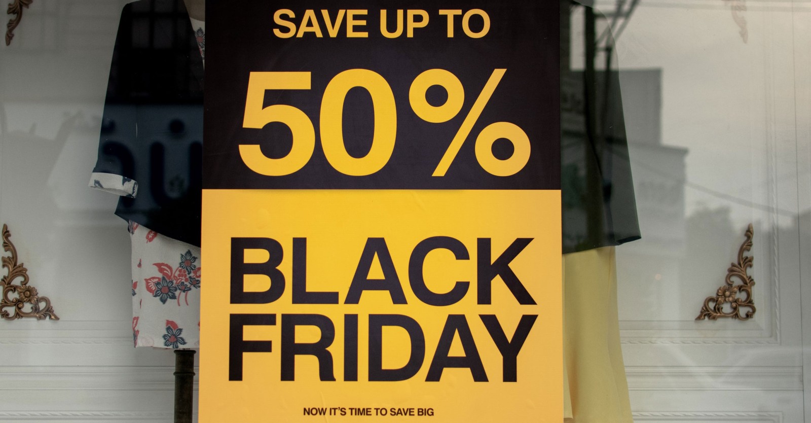 Black and yellow poster in a shop window advertising Black Friday