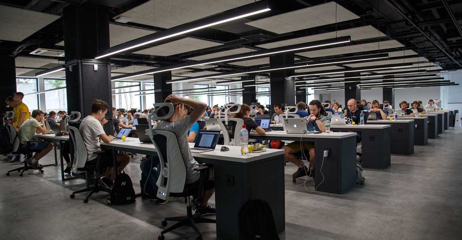 large room with employees at desks 