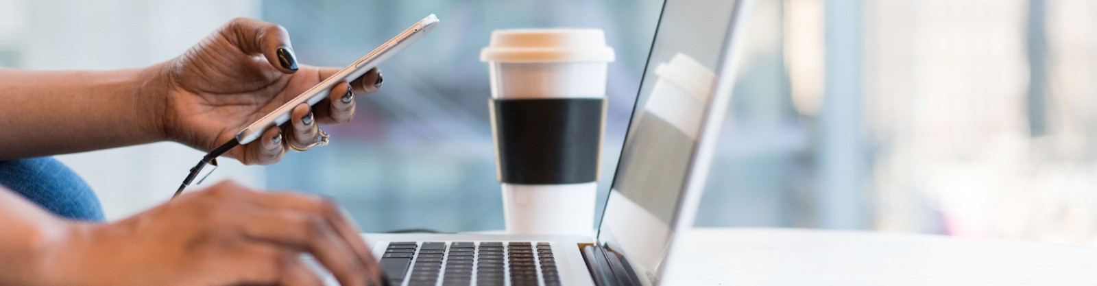 A person with a laptop and a mobile phone