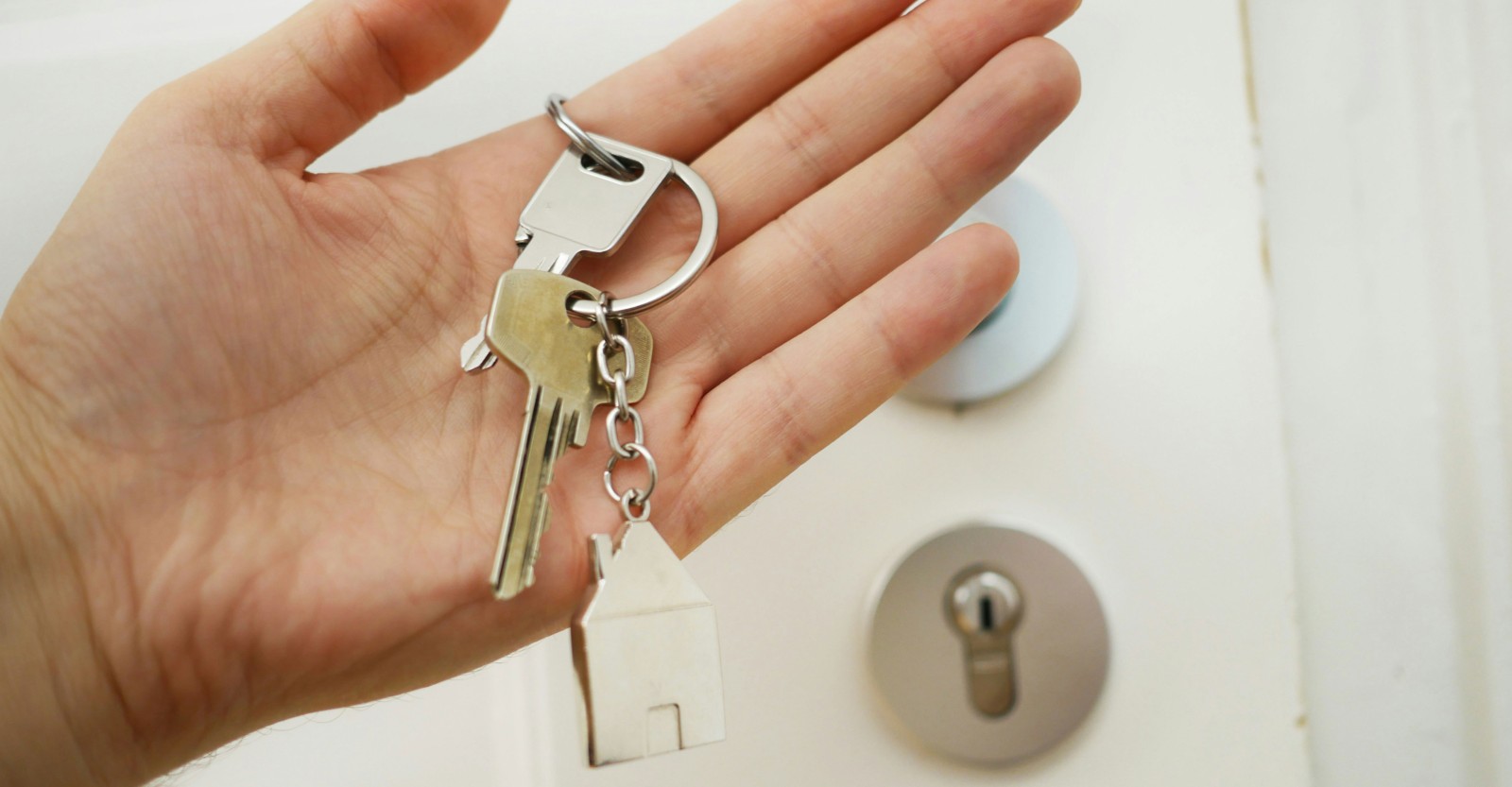 Keys on a keyring being held by a hand