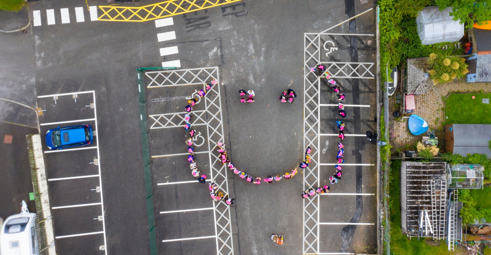 People stood in a smiley face formation  - seen from above