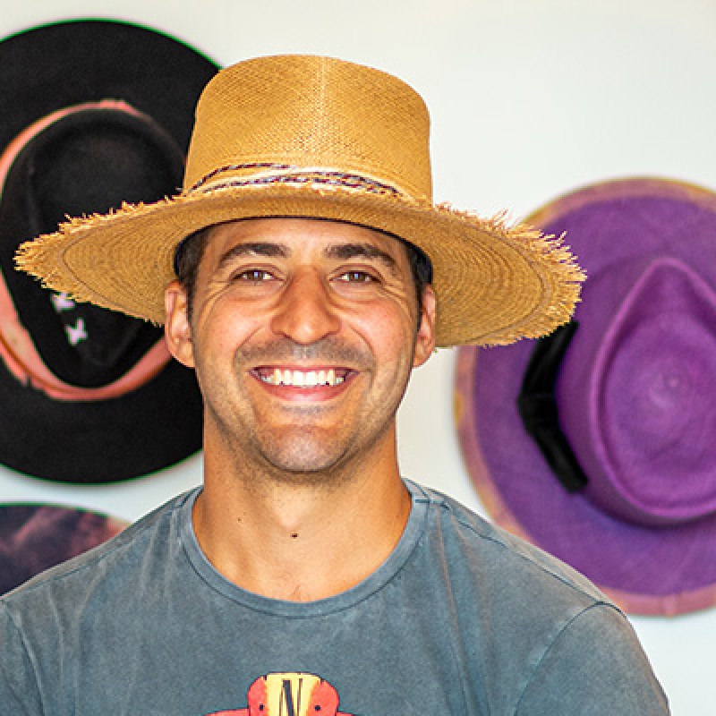 Marcel with hats on wall