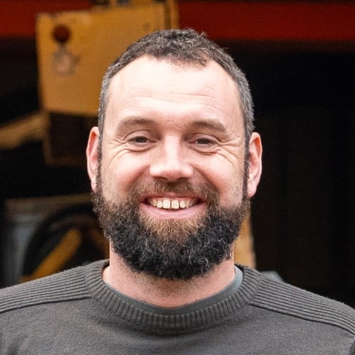 A headshot of a person siling