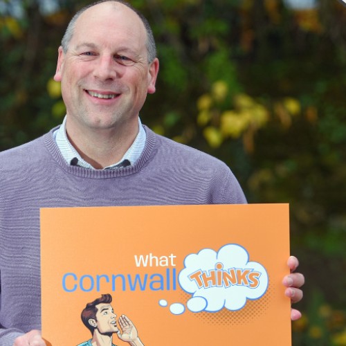 A person holding an orange poster